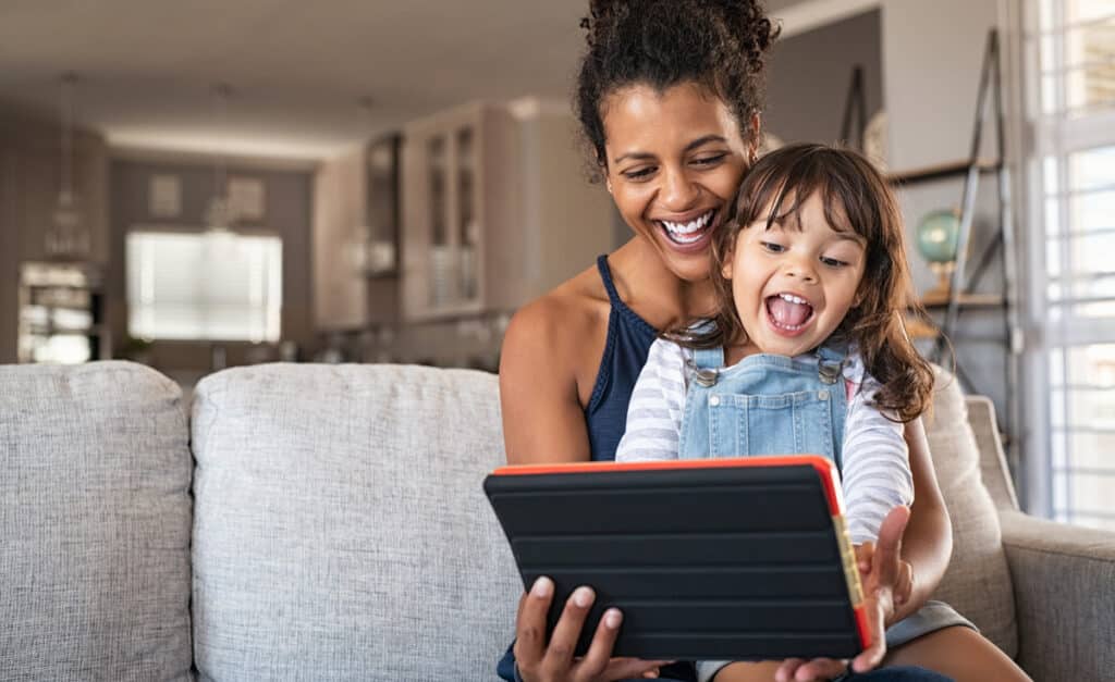 Mother and daughter accessing the internet with their tablet.