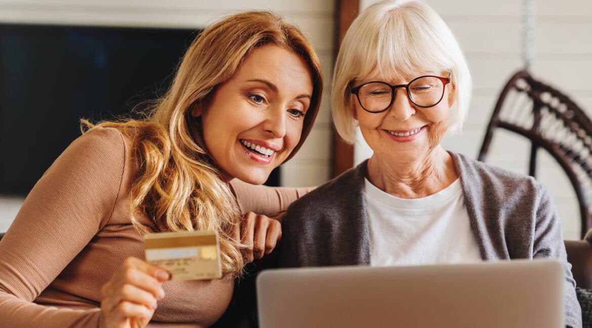 mother and daughter inputting credit card information online