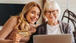 mother and daughter inputting credit card information online